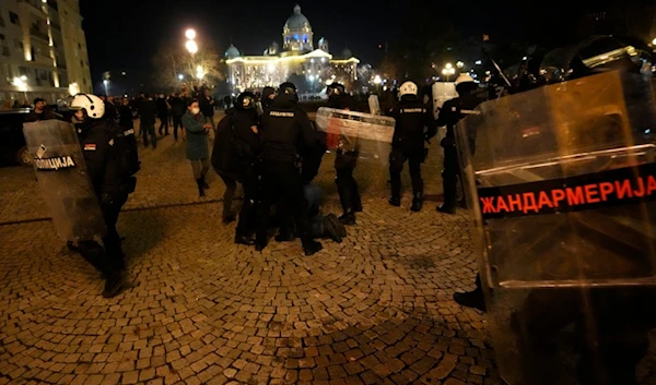 Protesters clash with gendarme in Belgrade, Serbia, Sunday, Dec. 24, 2023. (AP)