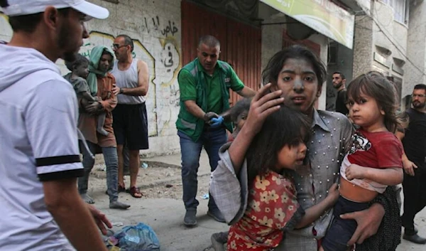 A child flee with her siblings after an Israeli airstrike in Gaza City. (AFP via Getty Images)