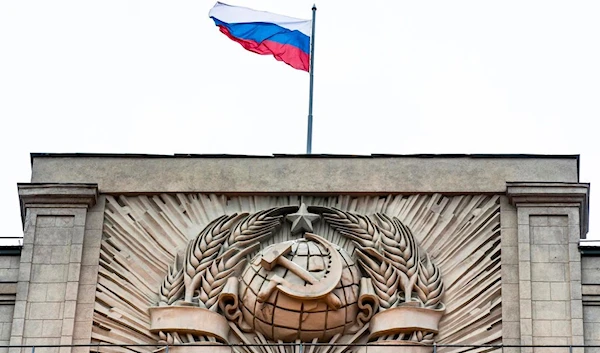 A Russian state flag flies above a hammer and sickle at the State Duma, lower parliament chamber, headquarters in Moscow, Russia, Tuesday, Feb. 14, 2017 (AP)