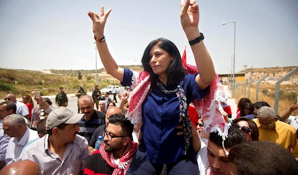 In this June 3, 2016 file photo, Palestinian PFLP leader and liberated detainee Khalida Jarrar is greeted by supporters after her release from an Israeli prison at the Jabara checkpoint near the West Bank town of Tulkarem, occupied Palestine. (AP)