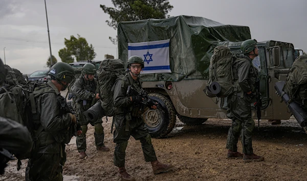 Israeli soldiers prepare to enter the Gaza Strip, at a staging area near Gaza, Wednesday, Dec. 13, 2023. (AP)