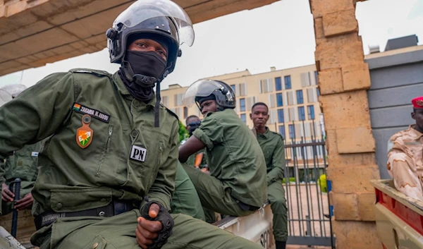 Nigerien police officers sit outside the customs offices in Niamey, Niger, on Aug. 21, 2023. (AP)