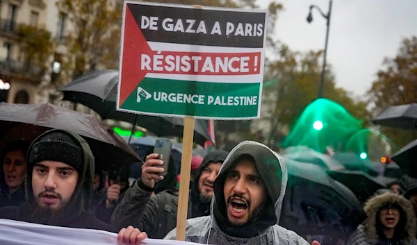 People chant slogans holding a banner that reads 'From Gaza to Paris - Residence - Emergency Palestine' during a pro-Palestinian rally, in Paris, Saturday, Nov. 18, 2023. (AP)