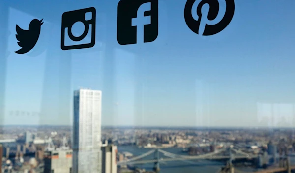 Icons for Twitter, Instagram, Facebook, and Pinterest are displayed on a window, New York, Wednesday, Jan. 13, 2016 (AP)