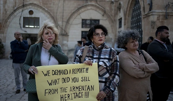 Members of the Armenian community protest a contentious deal to hand over a large section of the Armenian Quarter in the occupied Old City of al-Quds, occupied Palestine, May 19, 2023. (AP)