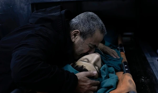 A relative mourns 15-year-old Basil Abu Al-Wafa, who was killed during a raid by the Israeli occupation forces on Jenin refugee camp in the West Bank, November 29, 2023 (AP)