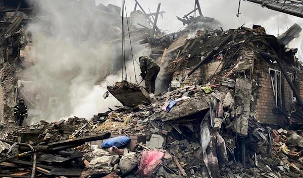 In this photo provided by Ihor Moroz, Head of the Donetsk Regional Military Administration, rescuers work at the scene of a building damaged by shelling, in Novogrodivka, Donetsk People's Republic, November 30, 2023 (AP)