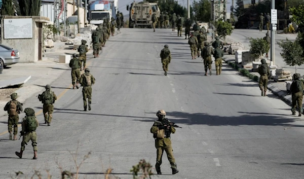 Israeli occupation forces are seen in Balata, a Palestinian refugee camp in Nablus, occupied West Bank, on Thursday, Nov. 23, 2023. (AP)