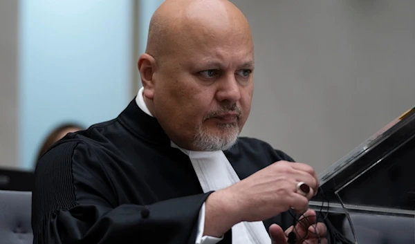 Public Prosecutor Karim Khan prepares for the trial of Mahamat Said Abdel Kani at the International Criminal Court in The Hague, Netherlands, Monday, Sept. 26, 2022. (AP)