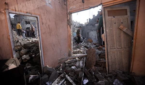 Palestinians look at destruction after the Israeli bombing In Khan Younis refugee camp in Gaza Strip on Friday, Dec. 1, 2023. (AP)