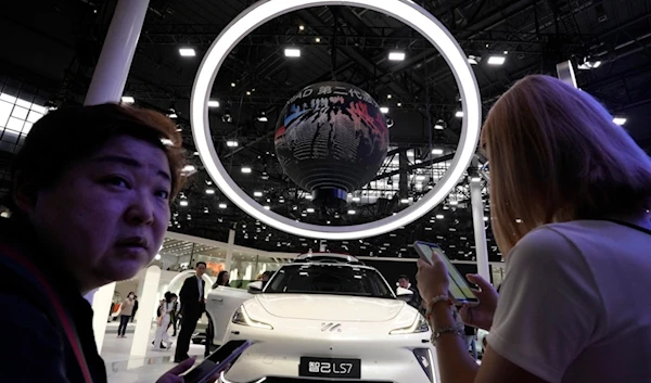 Attendees visit the booth of Chinese car brand iM during the Shanghai 2023 show in Shanghai, Wednesday, April 19, 2023. (AP)