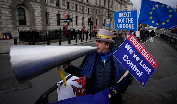 Anti-Brexit protester Steve Bray demonstrates on the edge of Parliament Square across the street from the Houses of Parliament, in London, Wednesday, Dec. 8, 2021. (AP)