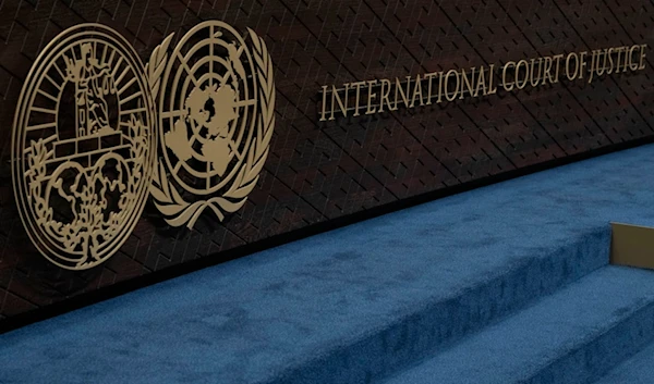 The logo of the International Court of Justice, left, and that of the UN, right, are seen on the judges bench at the International Court of Justice, in The Hague, Netherlands, Oct. 12, 2023. (AP)