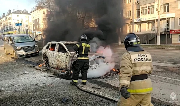 In this photo taken from video released by Russia Emergency Situations Ministry telegram channel on Saturday, Dec. 30, 2023, Firefighters extinguish burning cars after shelling in Belgorod, Russia. (AP)