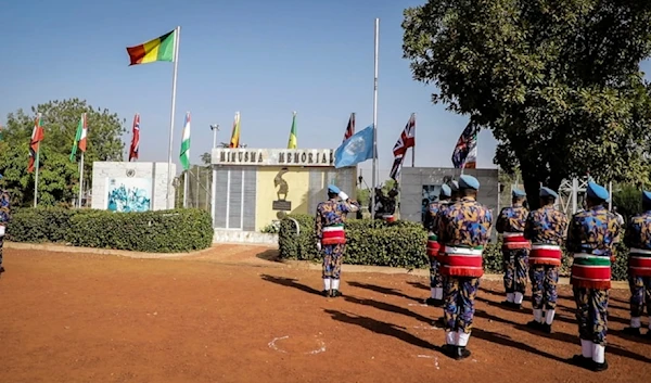 U.N. MINUSMA troops from Bangladesh hoist down the U.N flag for the last time at a departure ceremony held in Bamako, Mali, Monday, Dec. 11, 2023. (AP)