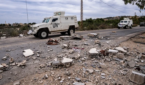 UN peacekeepers patrol next to a damaged house in the southern village of Marwahin, Lebanon, November 25, 2023 (AP)