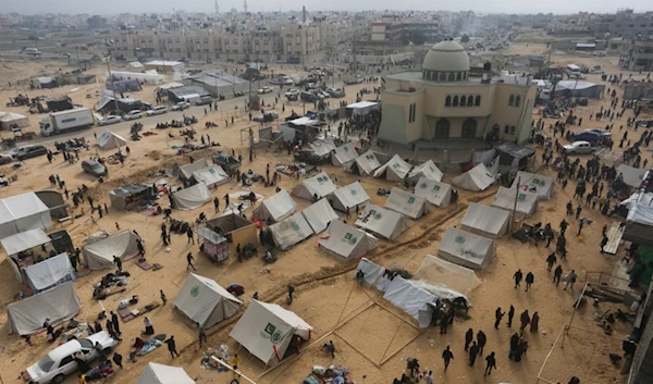 Palestinians fleeing the Israeli genocide arrive in Rafah, Gaza Strip, Tuesday, Dec. 5, 2023 (AP Photo/Hatem Ali)