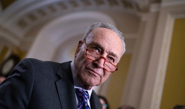 Senate Majority Leader Chuck Schumer, D-N.Y., answers questions from reporters outside the Senate chamber, at the Capitol in Washington, Tuesday, Nov. 28, 2023 (AP)