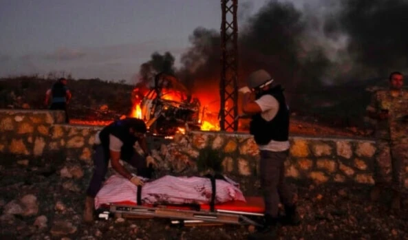 Civil Defense workers remove the body of Reuters videographer Issam Abdallah who was killed by an Israeli shelling, at Alma al-Shaab, south Lebanon, Friday, October 13, 2023. (AP)