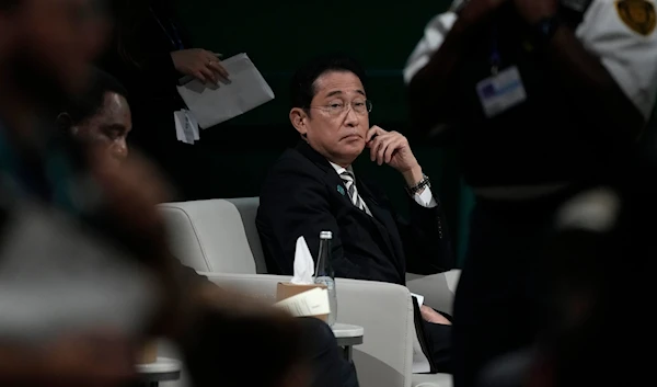 Japan Prime Minister Fumio Kishida sits during a plenary session at the COP28 U.N. Climate Summit, Friday, Dec. 1, 2023, in Dubai, United Arab Emirates. (AP0