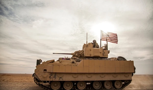 American soldiers drive a Bradley fighting vehicle during a joint exercise with Syrian Democratic Forces at the countryside of Deir Ezzor in northeastern Syria, Dec. 8, 2021 (AP)