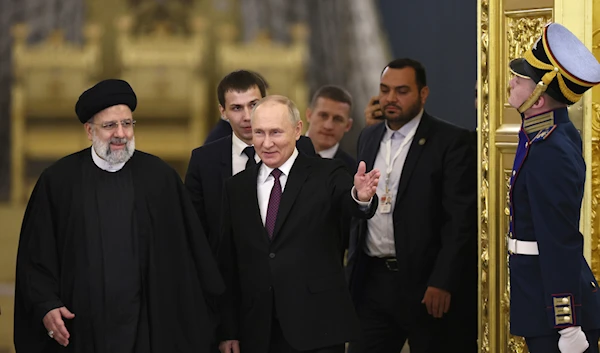 Russian President Vladimir Putin, center, welcomes Iranian President Ebrahim Raisi, left, for the talks at the Kremlin in Moscow, Russia, Thursday, Dec. 7, 2023. (AP)