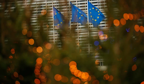 European Union flags flutter in the wind at EU headquarters in Brussels, Sunday, Dec. 6, 2020.