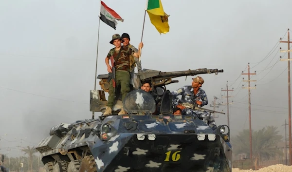 Iraqi Hezbollah Brigade fighters patrol on the front line in eastern Husaybah, 8 kilometers east of Ramadi, Iraq, June 4, 2015 (AP)