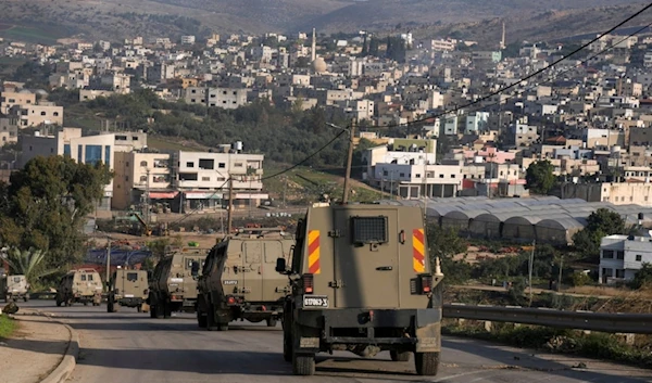 A convoy of Israeli army vehicles is seen during a military raid into Faraa refugee camp, West Bank, Friday, Dec. 8, 2023. (AP)