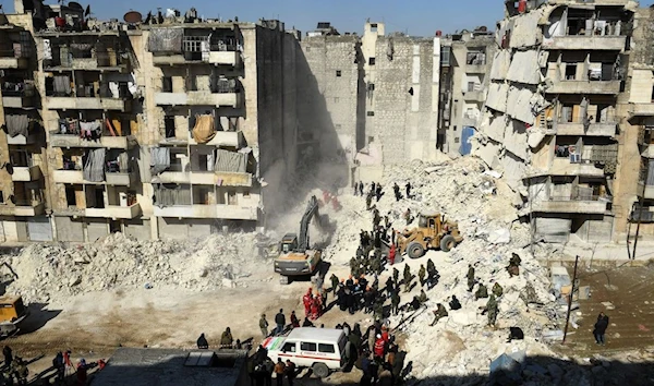 =Syrian soldiers aid rescuers amid the rubble of a collapsed building in the northern city of Aleppo on February 9, 2023. (AFP)