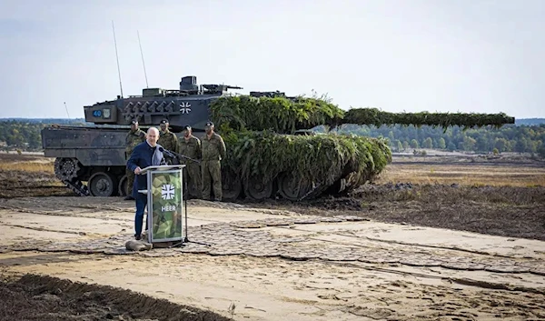 German Chancellor Olaf Scholz speaks to soldiers in front of a Leopard 2 main battle tank after the Army's training and instruction exercise in Ostenholz, Germany, Monday, oct. 17, 2022. (AP)