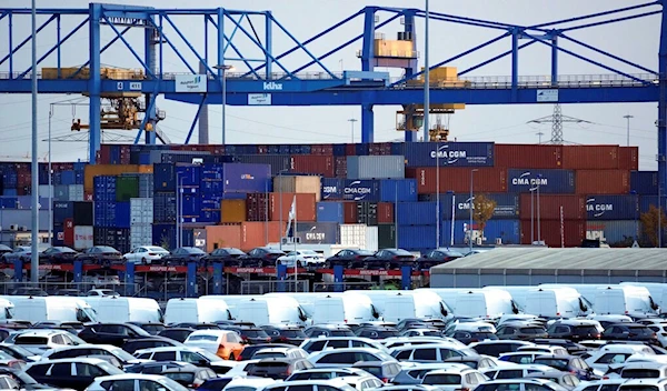 Cars and containers are pictured at the 'duisport logport' logistics center at the river Rhine in Duisburg, Germany, Friday, Oct. 28, 2022 (AP Photo/Michael Sohn)