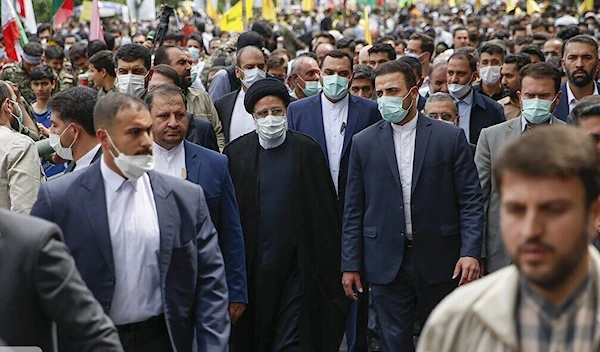 President Raisi marching with citizens on the anniversary of the Iranian revolution