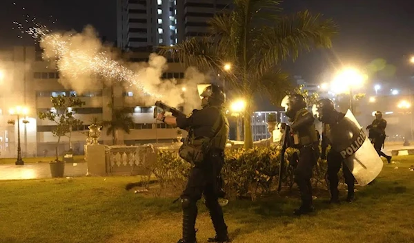 Riot police fire tear gas at anti-government protesters in Lima, Peru, Friday, Jan. 20, 2023.