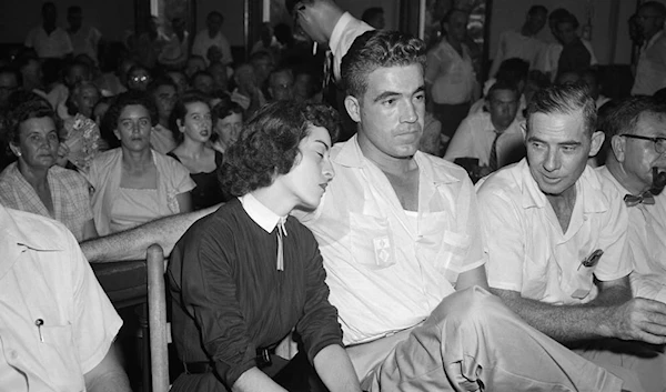 In this Sept. 22. 1955 photo, Carolyn Bryant rests her head on her husband Roy Bryant's shoulder after she testified in Emmett Till murder court case in Sumner. (AP)