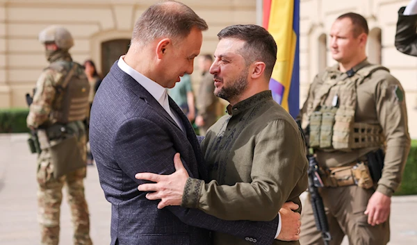 Ukrainian President Volodymyr Zelensky and Polish President Andrzej Duda hug each other as they meet in Kyiv, Ukraine on August 23, 2022 (Polish Presidential Press Service via Reuters)