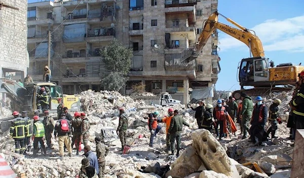 Members of the Algerian rescue team and Syrian army soldiers search for survivors at the site of a damaged building, in the aftermath of the earthquake in Aleppo, Syria February 8, 2023 (Reuters).