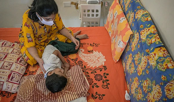 Vihaan doing physiotherapy after a session with the nebulizer. (NYT)