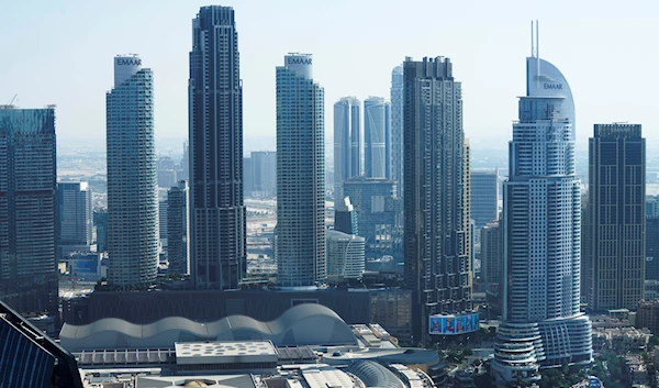 The Address Downtown hotel, right, is seen near the Dubai Mall, bottom left, in Dubai, United Arab Emirates, Thursday, Nov. 17, 2022 (AP Photo/Jon Gambrell)