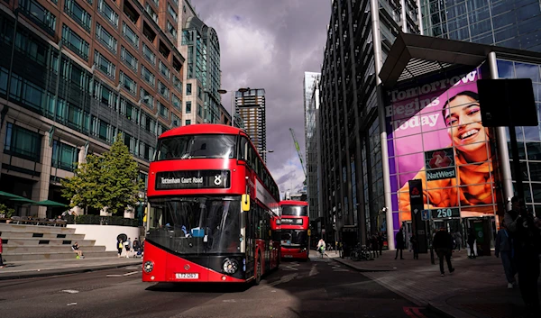 Buses drive past Liverpool Street station, in the financial district known as The City, in London, Friday, Oct. 7, 2022  (AP Photo/Alberto Pezzali)