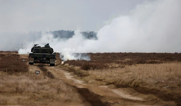 Ukrainian and Polish soldiers drive the Leopard 2 tank during a training at a military base and test range in Swietoszow, Poland, Monday, Feb. 13, 2023 (AP Photo/Michal Dyjuk)