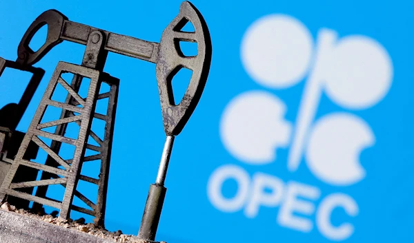 A 3D-printed oil pump jack is seen in front of displayed OPEC logo in this illustration picture, April 14, 2020. (REUTERS)