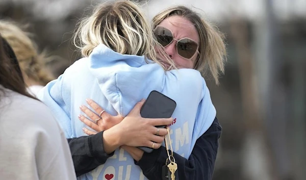 Students hug on the Michigan State University campus in East Lansing, Mich., Tuesday, Feb. 14, 2023. (AP)