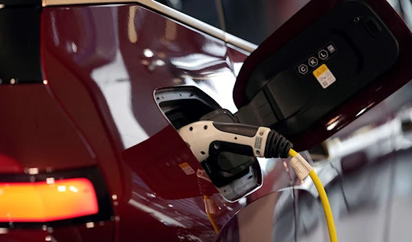 A new electric BMW iX car of German car manufacturer BMW is charging in Munich, Germany, Friday, Oct. 22, 2021 (AP Photo/Matthias Schrader, File)