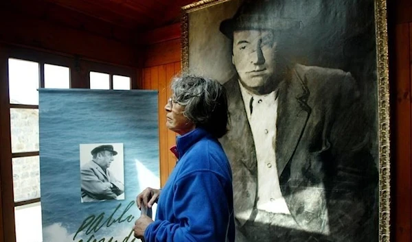 A woman looks at a painting of Chilean poet and Nobel laureate Pablo Neruda during a ceremony the 30th anniversary of his death, in Isla Negra, west of Santiago, September 23, 2003. (REUTERS)