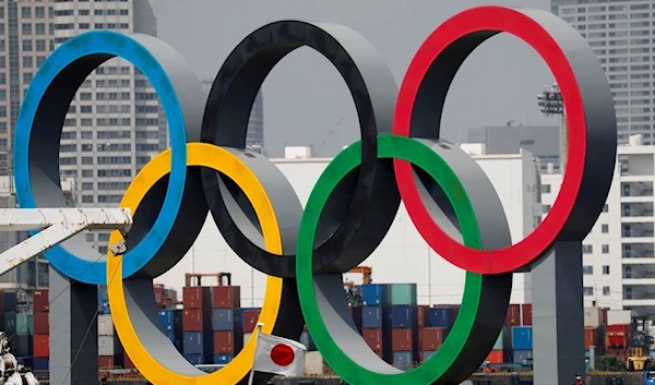 Giant Olympic rings are seen behind Japan's national flag (REUTERS)