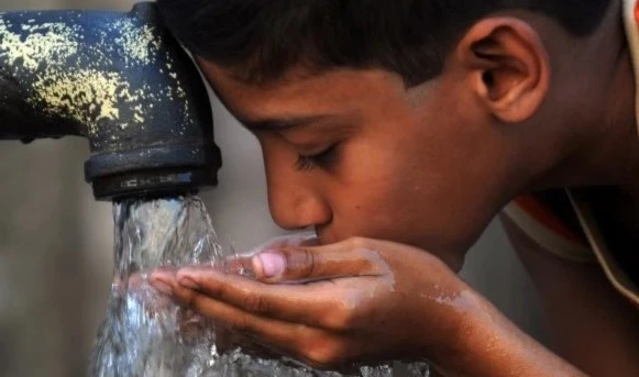 =A boy drinking from a water tap in India. (AFP)