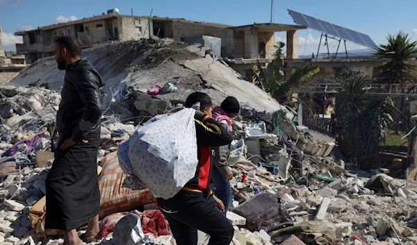 People searching in the rubble for their belongings in Aleppo, Syria (AP)