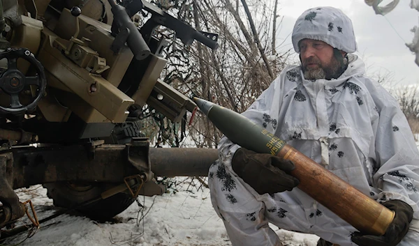 A Ukrainian soldier prepares to fire an artillery at Russian positions near Bakhmut, Donetsk region, Ukraine, Wednesday, Feb. 15, 2023 (AP).