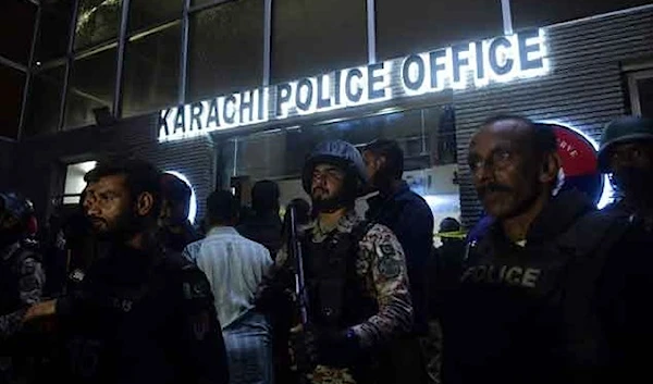 Security personnel stand guard outside the Karachi Police Office after it was attacked by terrorists on February 17, 2023. (AFP)